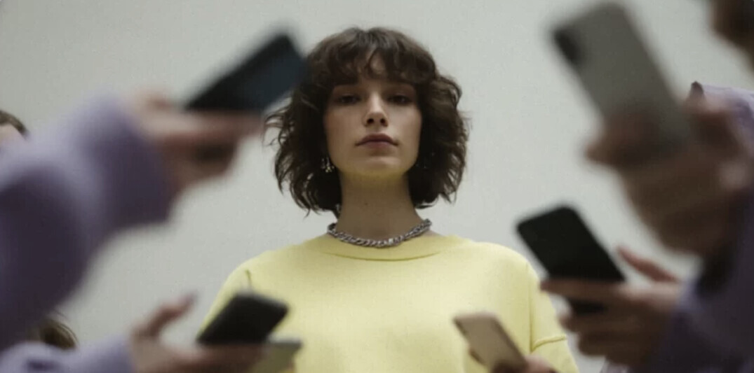 Close up person holding a smartphone showing dating app profile, reflecting modern digital fatigue and dopamine loop concept at QiKiSol